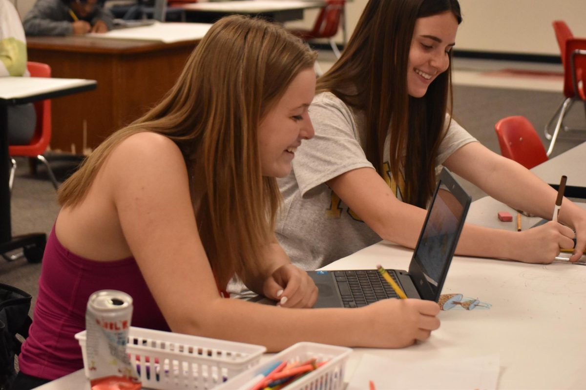 Colleen Gardunia (10) and Lizzy Wagner (10) are coming up with ideas for their AP World History project on April 24 in the history commons. 
