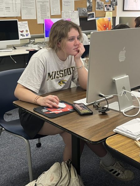 Brie Williams (12) working on writing and editing stories during newspaper class on May 1. 