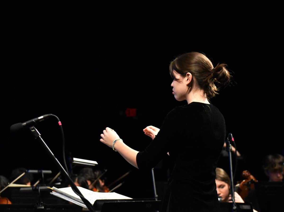 Macey Heimburger (10) conducts  symphonic orchestra during spring concert on May 9.