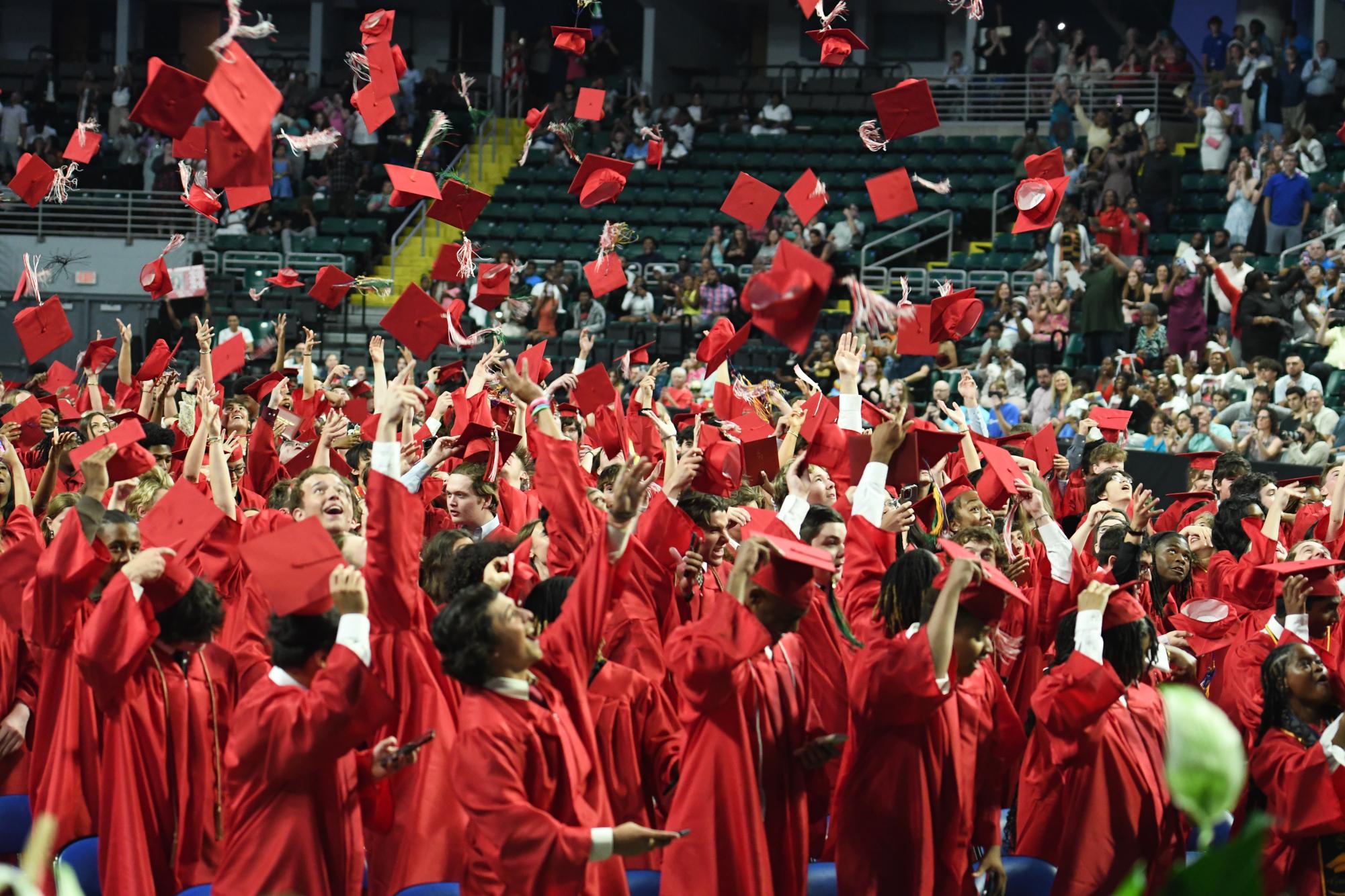 On May 21, the seniors celebrate their graduation at St. Charles Family Arena by throwing their caps in the air.