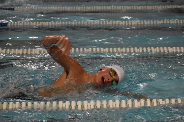 Brody Blatt (11) warms up for the 500 freestyle at SLUH on Sept. 4 during a dual meet. 