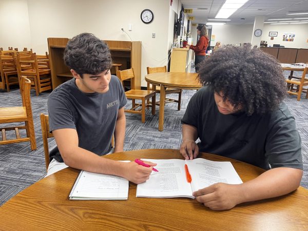 Alan Conway (12) tutors Steven Luera (11) during academic lab. 