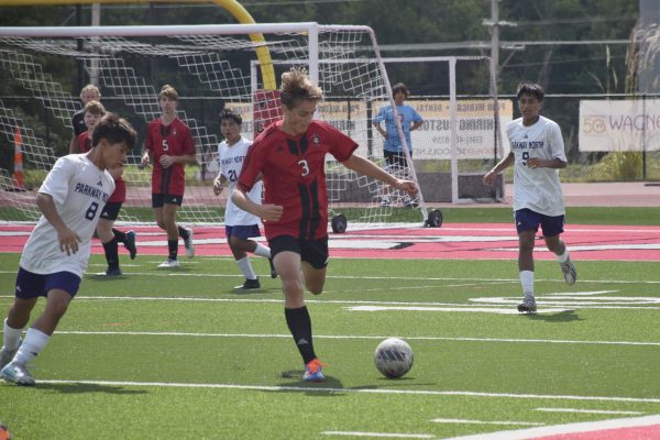 Till Soltau (11) defensively dribbles and kicks the ball away from the PCH goal on September 14 as Jackson Sasfai (10) watches the play. Soltau is a new German exchange student at PCH. "I am ready to win some games,” Soltau said.