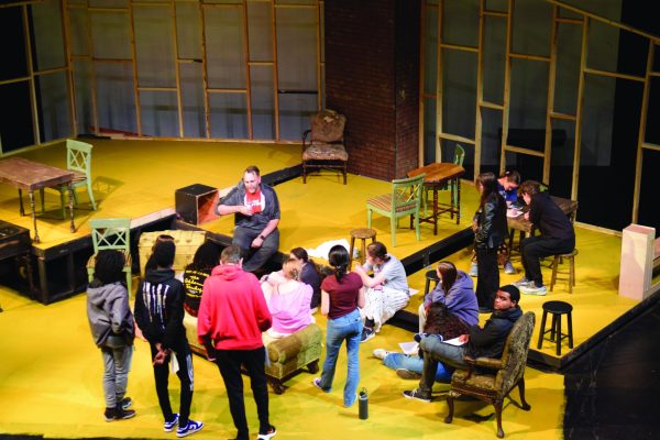 The cast of "Little Women" discuss during rehearsal.  