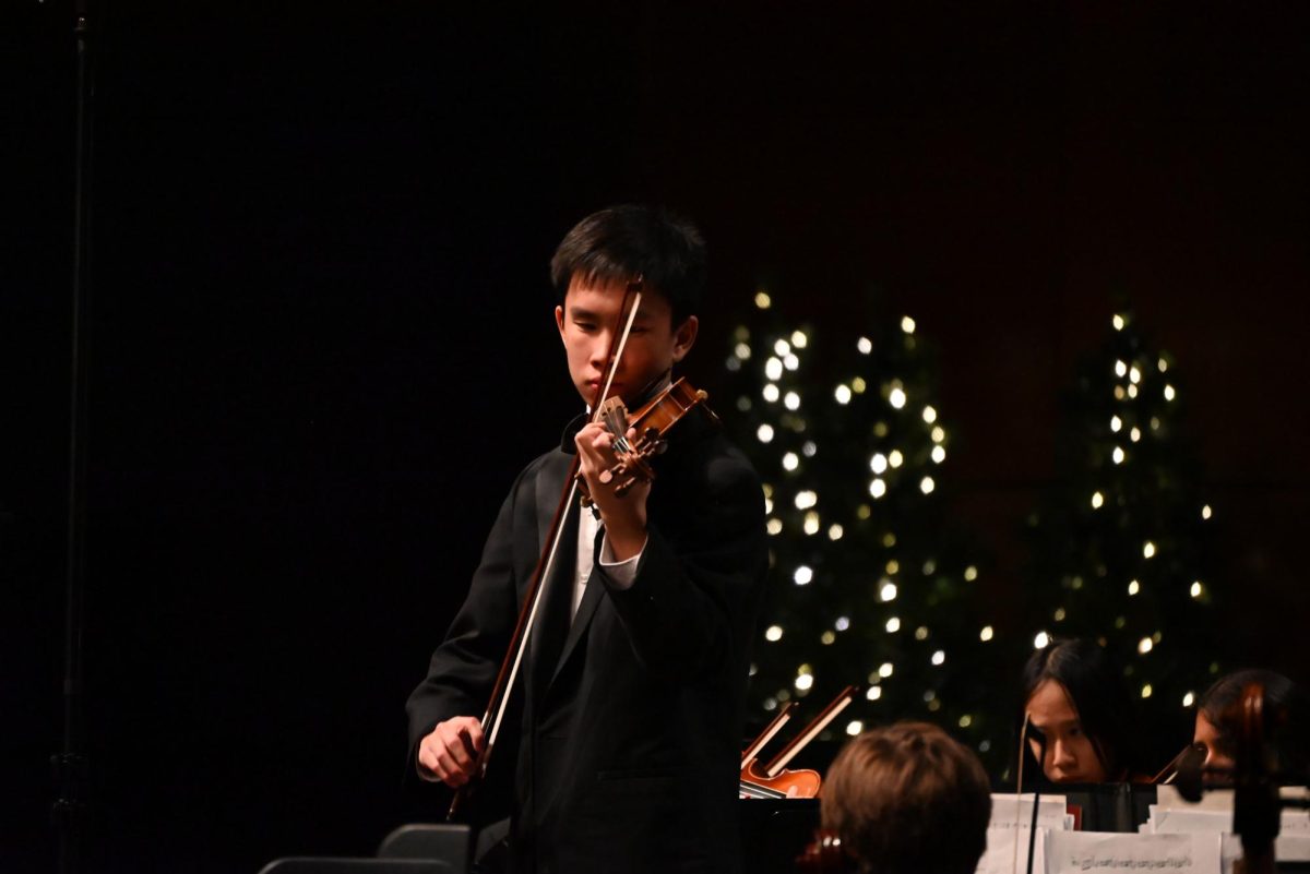 Senior Asher Koh plays violin solo during orchestra's Masterwork concert on Dec. 11. Photo by Jillian Pallia