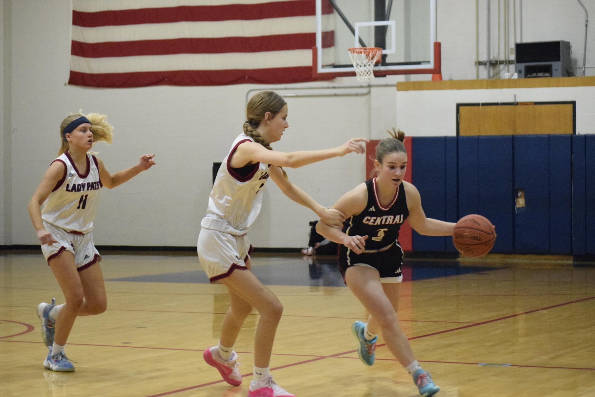 Kiera Gravely (12) dribbles the basketball down the court for the teams first game against Parkway South on Nov. 25. Gravely collected 3 rebounds and 2 assists to put the pressure on South throughout the game.