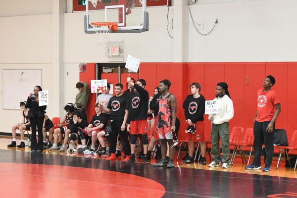 The wrestling team looks on from the sidelines as their teammate Alise Yn (12) is honored for Senior Night on Jan.. 22.