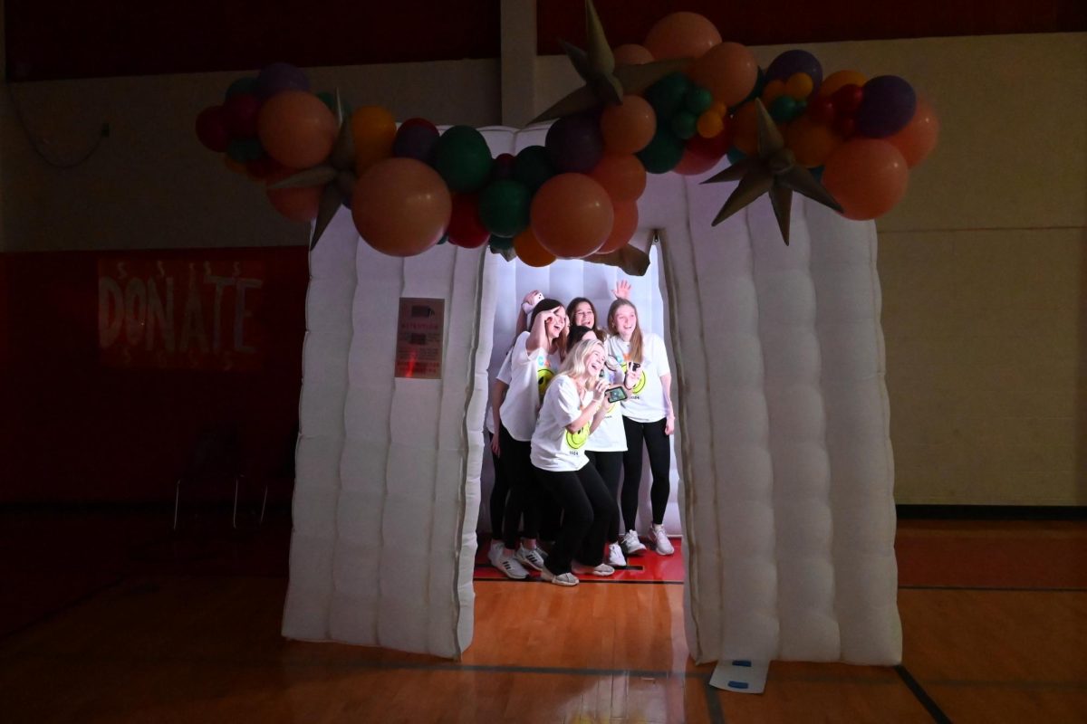 Students pose in the photo booth at Dance Marathon in February 2024. 