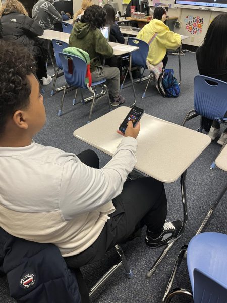 Sophomore Luke Culpepper sits in class on his phone. 