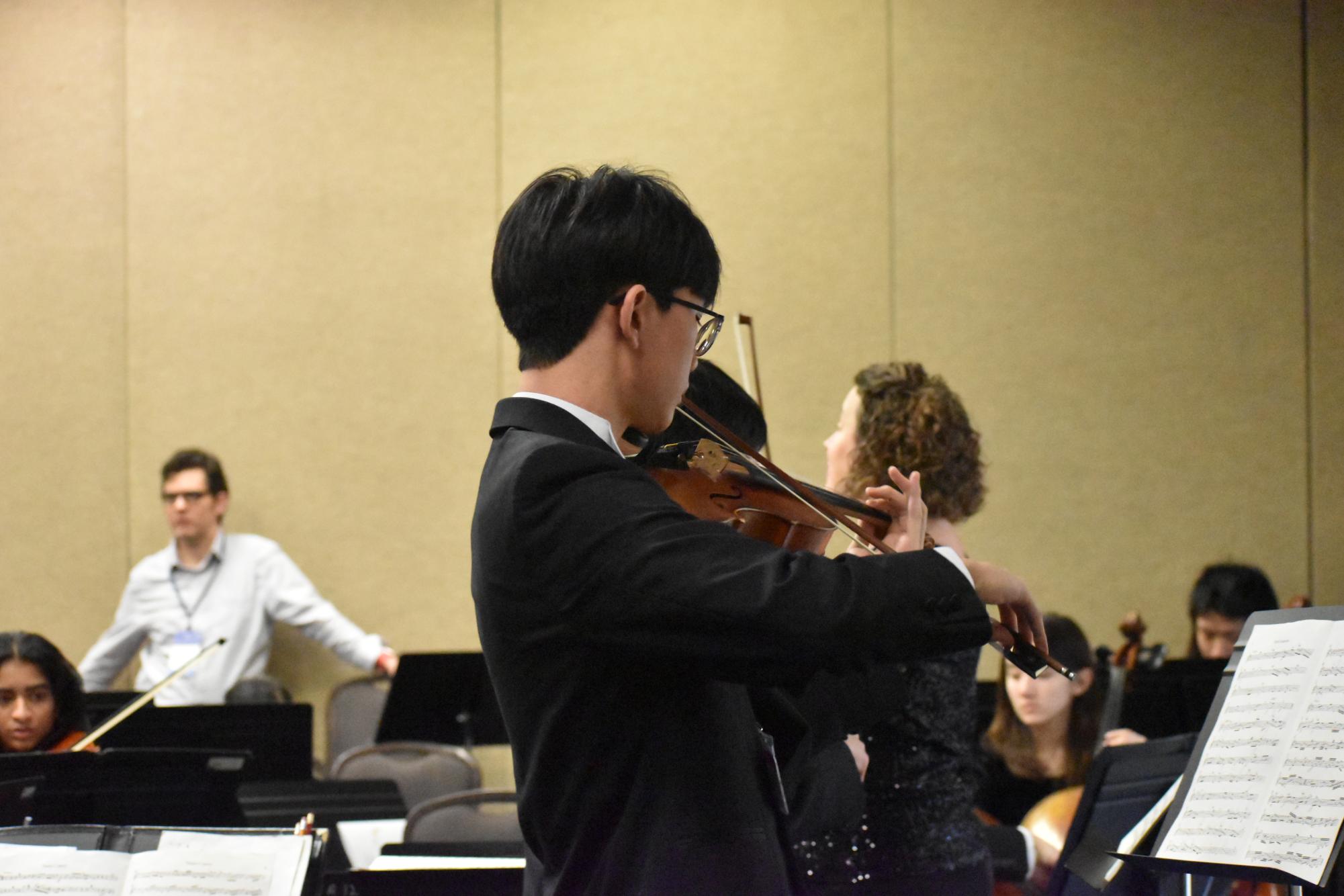 Aiden Moon (11) rehearses his solo with the orchestra before the performance on Jan. 30. 