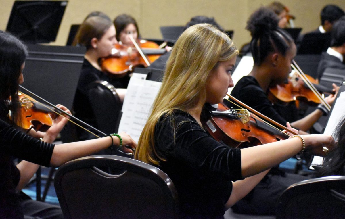 Brooke Williams (12) plays the violin during MMEA concert rehearsal on Jan. 30.