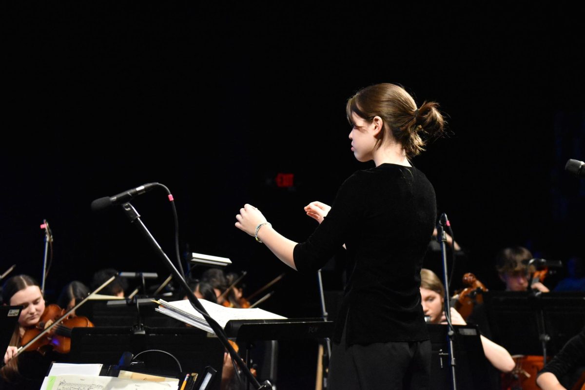Macey Heimburger(11) conducts a song at the orchestra concert on May 9, 2024.  