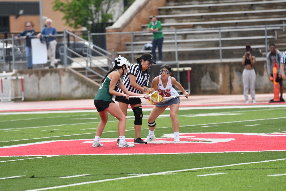 Sarah Jones (12) sets up for the draw to reset at the game against Pattonville on April 30. The Colts took the win against the Pirates to increase their winning streak. 