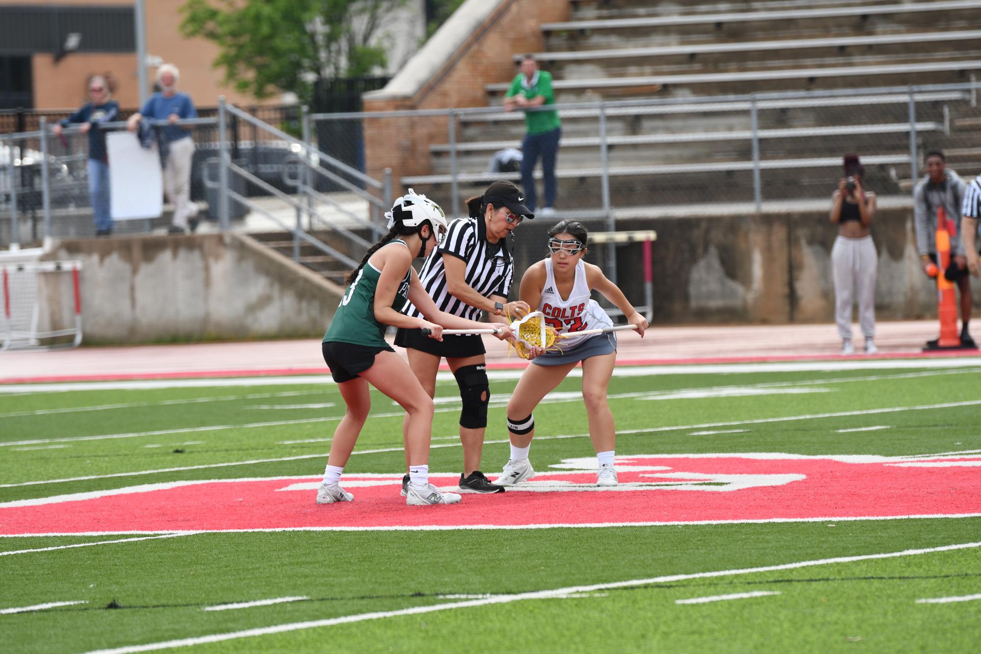 Sarah Jones (12) sets up for the draw to reset at the game against Pattonville on April 30. The Colts took the win against the Pirates to increase their winning streak. 