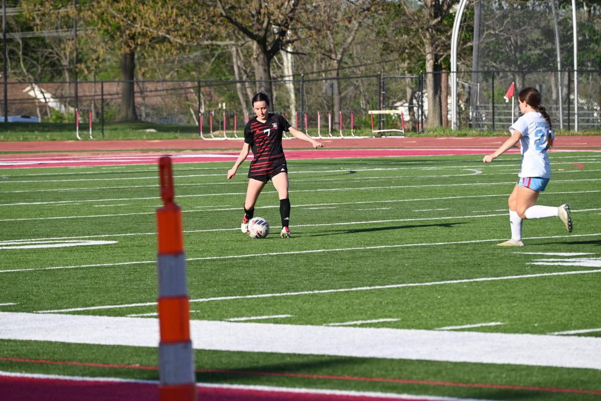 Senior Clare Johnston dribbles the ball down the field during the game against Parkway West on April 22. 