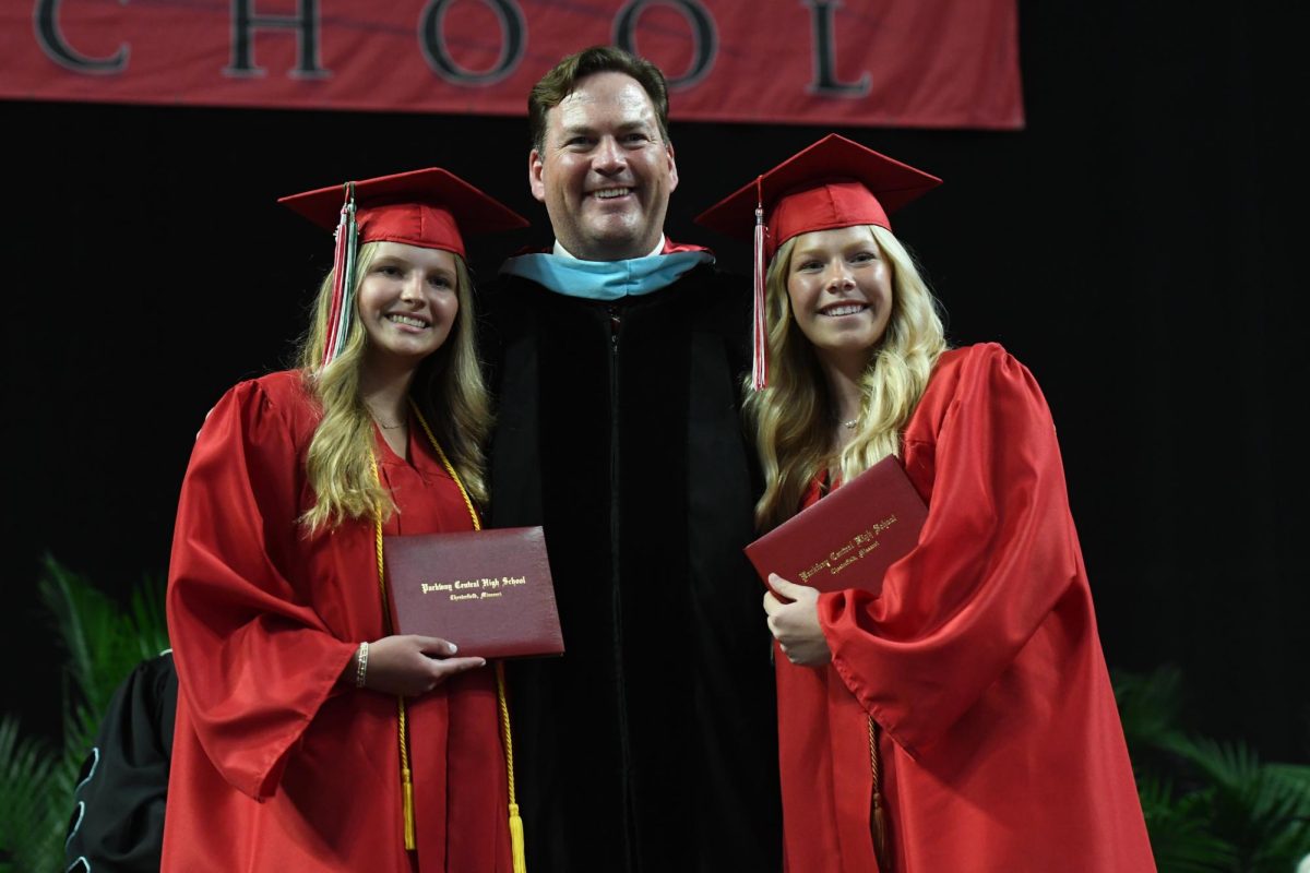 Twins Madison and Jamie Sevasko pose with their diplomas and Dr. Tim McCarthy at the 66th Parkway Central Commencement Ceremony at the Family Arena on May 20.