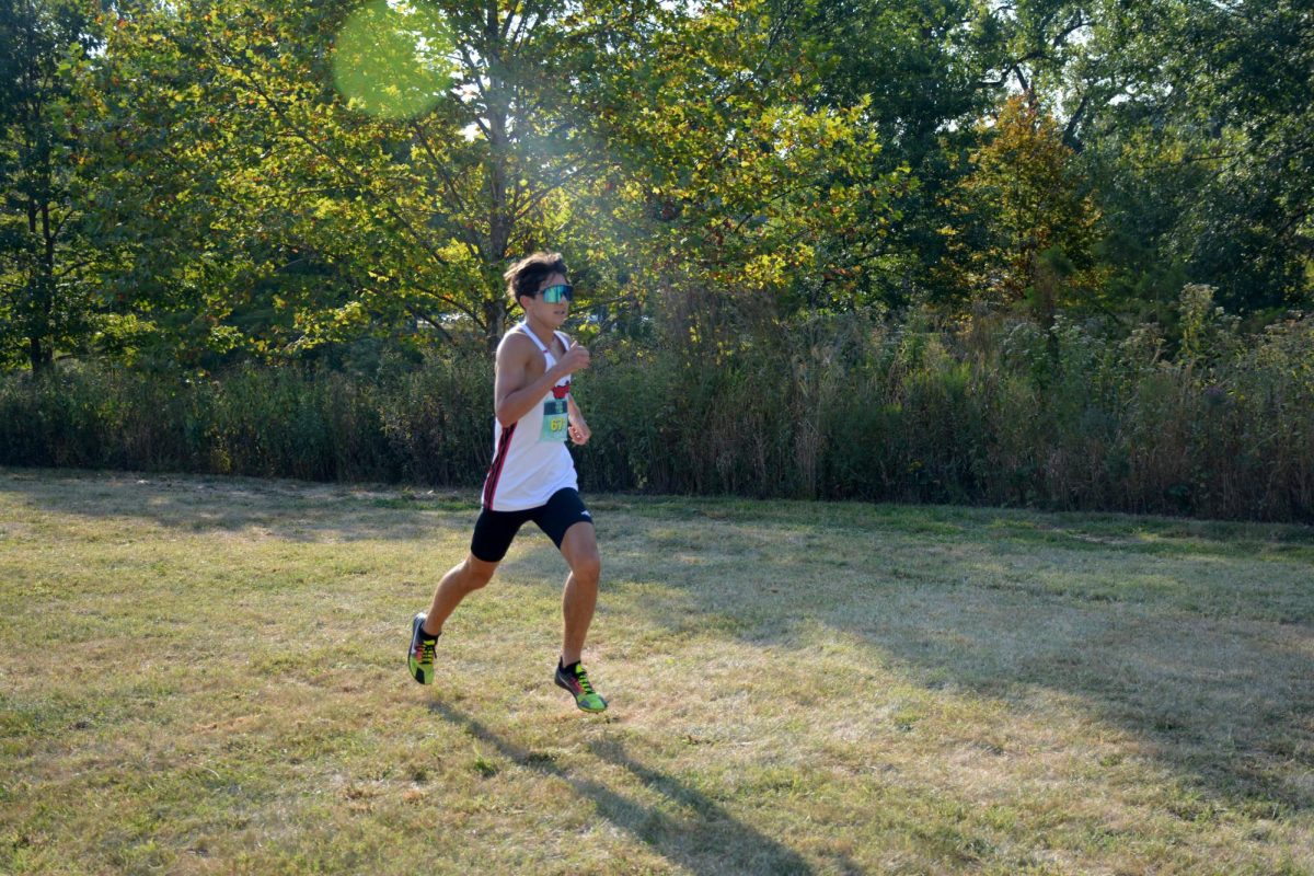 Sophomore Lucas Amador approaches the finish line at the Forest Park XC on Sept. 13. Amador placed seventh with a time of 15:51.4. 