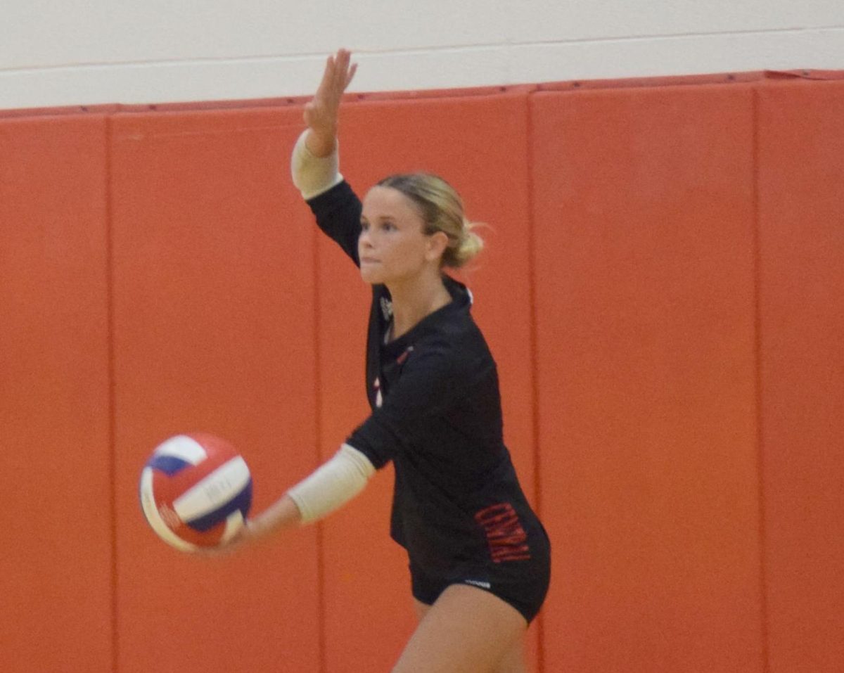Taylor Jesse(12) begins to serve against Rockwood Summit on Sept. 4.