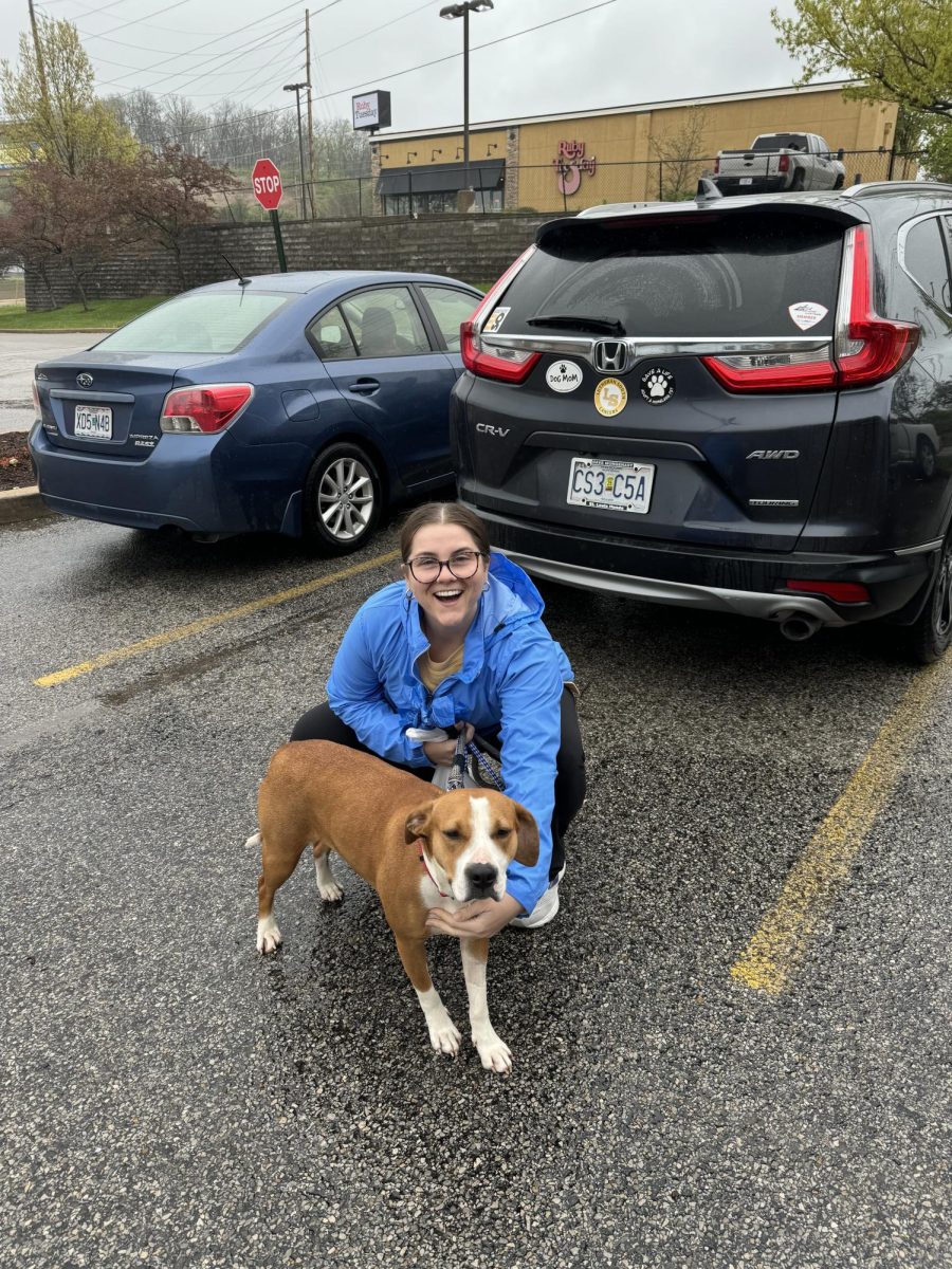 Sarah Petroff posing with her dog, Lady, in the parking lot. Petroff describes herself as a "crazy dog lady" and would like to have more dogs in the future. Photo courtesy of Petroff