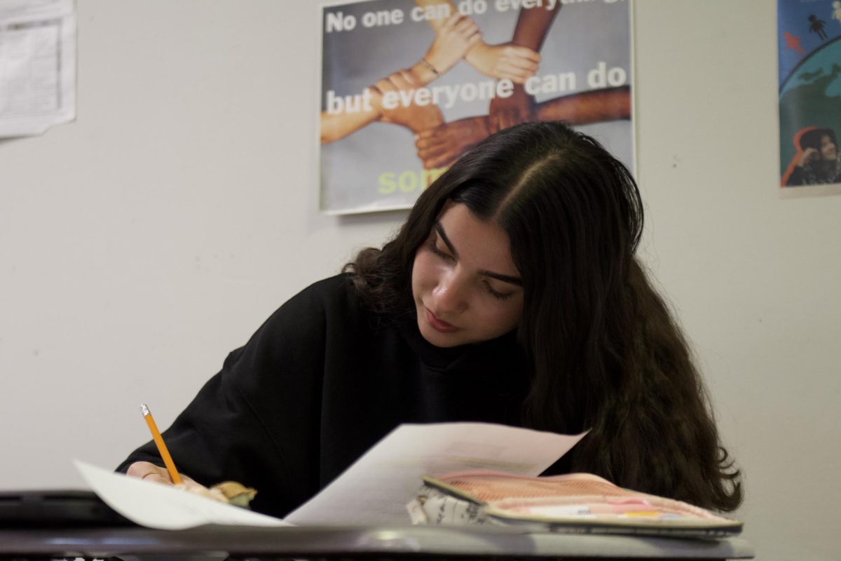Yasmine Benamor (11) works on classwork in ESL on Oct. 23. 