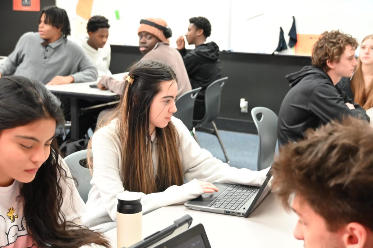 Candelaria Perez (12) works on her computer in Mr. Roger's college composition class on Dec. 9. 