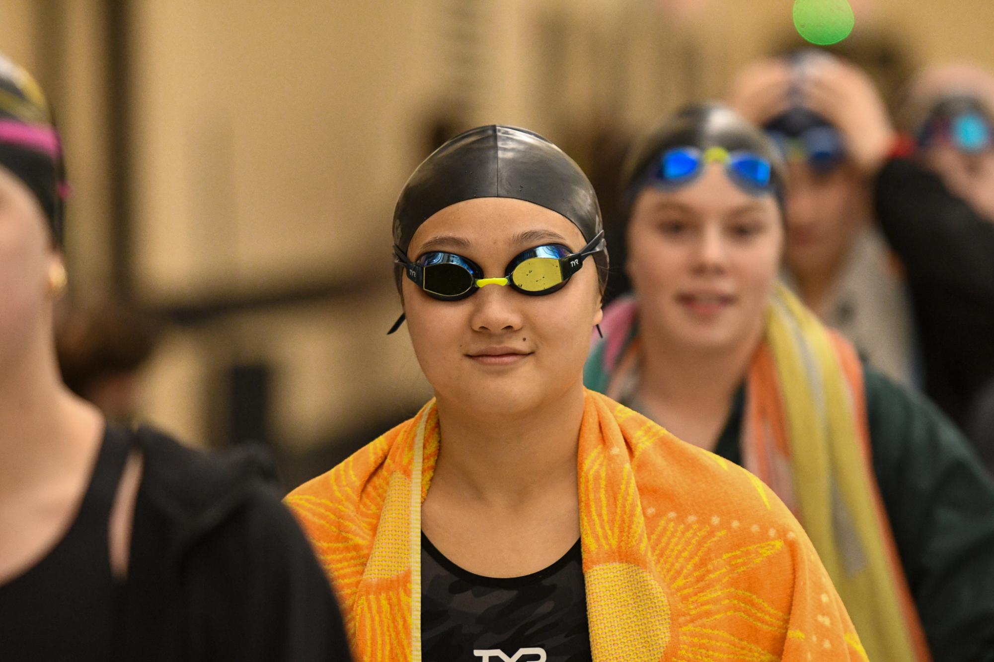 Serena Huang (12) walks out before the 100 Yard Breaststroke at the COMO Invitational on Jan. 10. Huang helped the varsity team place 4th overall.
