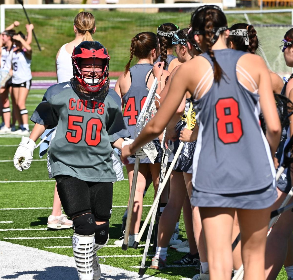 Bumbac was the goalie for Central's girls lacrosse team. Here, she high fives teammates before a game in 2024. 